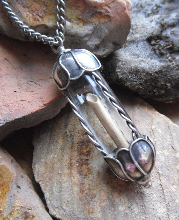 The Duchess’ glass and silver vial, here shown before it came into her possession, holding the remains of the straw that broke the camel’s back.